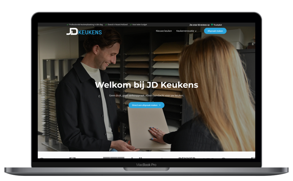 Laptop showing JD Keukens website.