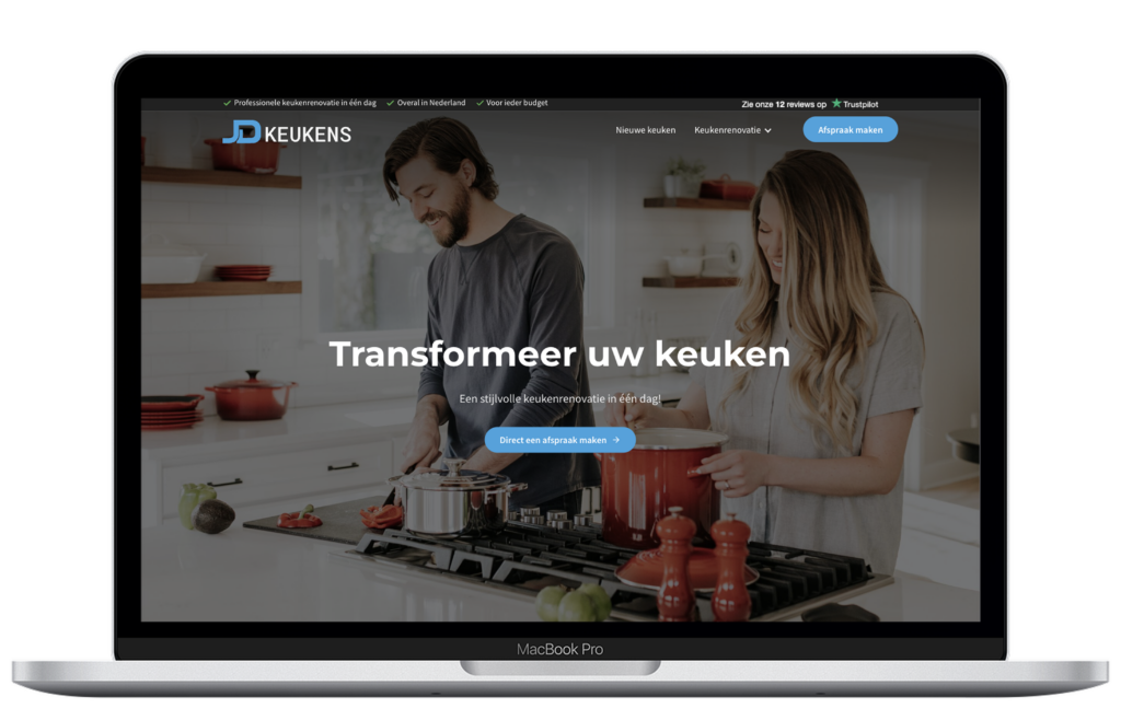Laptop showing JD Keukens website.